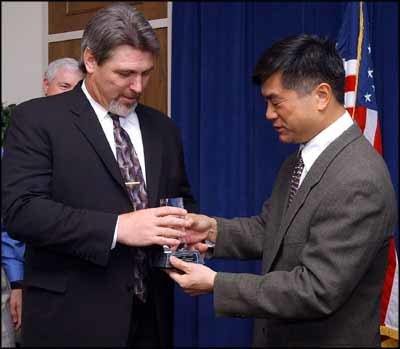 2003 FILE PHOTO — Former Gov. Gary Locke gives former Providence Centralia Hospital administrator Steve Burdick the Washington State Quality Award in a ceremony in the Governor's Office in 2003.