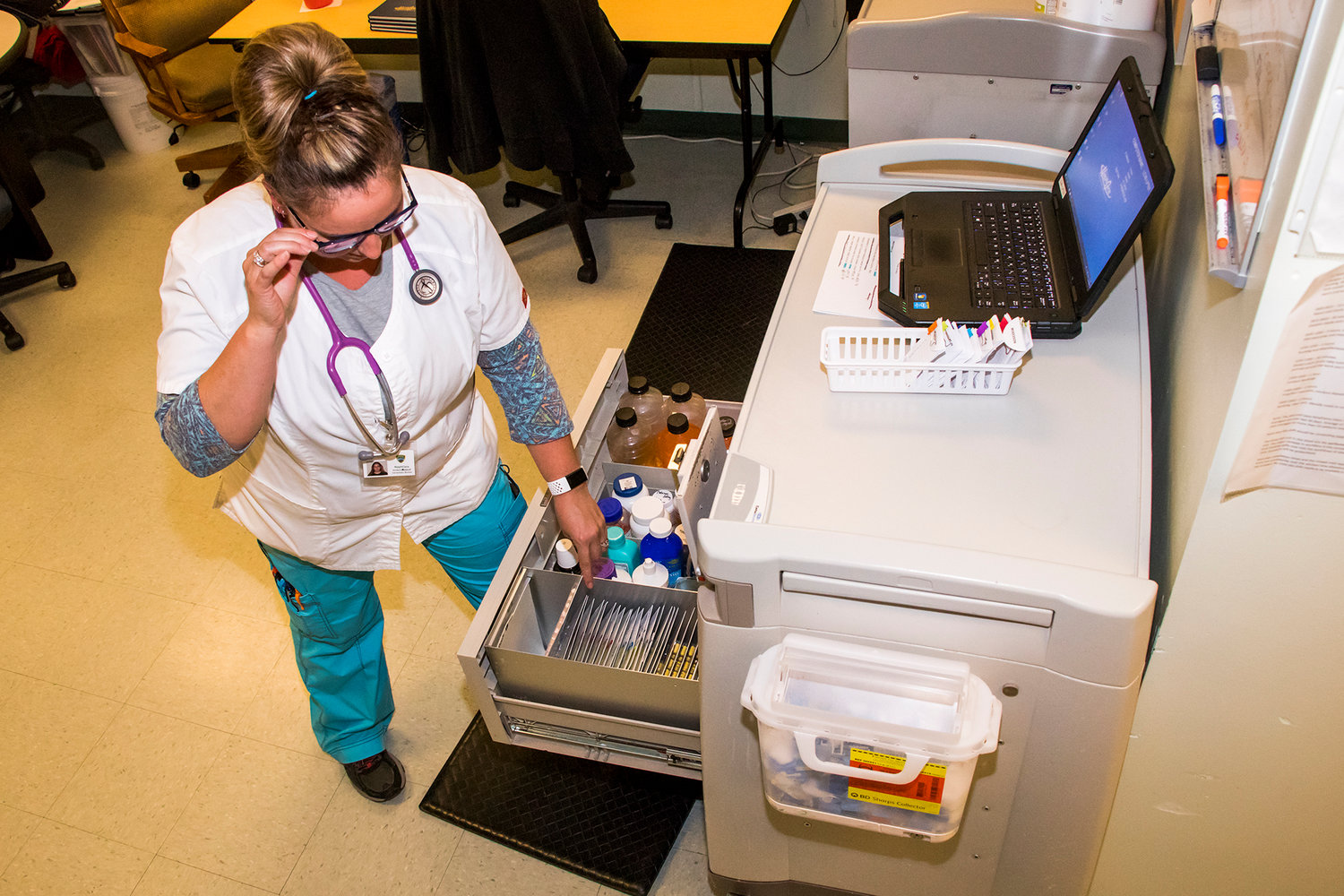 Licensed Practical Nurse Kim Heberer checks the contents of a cabinet in the Lewis County Jail's medical clinic in May 2019.