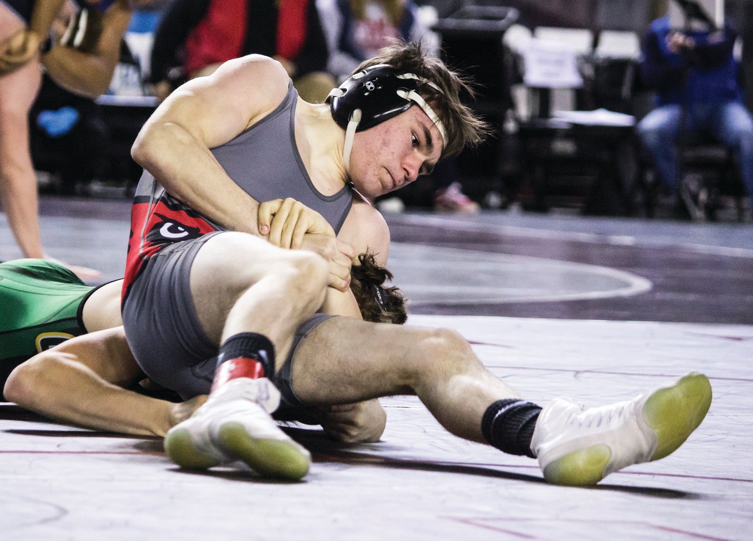 Winlock's Dusty Thayer, on top, wrestles an oppponent in the 1B/2B 126-pound bracket of the WIAA Mat Classic boys state wrestling tournament on Friday.