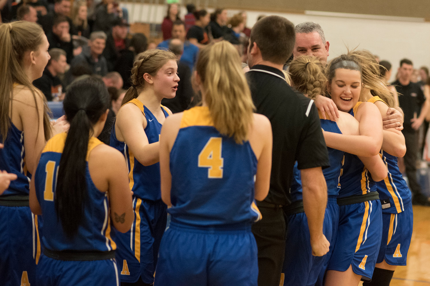 Adna players react after the final buzzer sounds on the Pirates 46-33 win over Rainier Thursday. (Eric Trent / etrent@chronline.com)