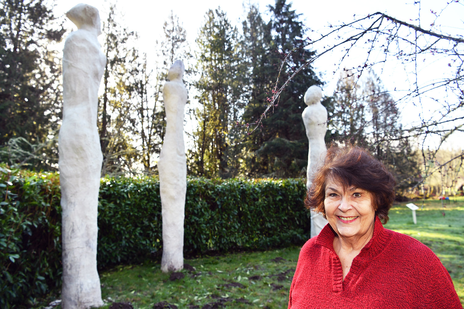 Rainier-area sculptor Myrna Orsini in front of her creation "Three Graces," a featured piece in her Monarch Sculpture Park.