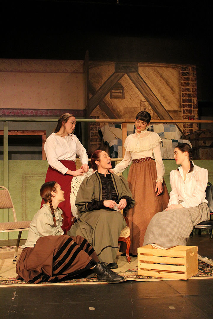 Mrs. March, portrayed by Kendra Heath, surrounded by her four daughters (from left to right): Jo, portrayed by Scarlet Nixon Klein; Beth, portrayed by Kirsten Scogin; Meg, portrayed by Isabel Nixon Klein; and Amy, portrayed by Talia Heath. "Little Women" opens as a dessert theater at the Roxy Theatre in Morton Feb. 14.