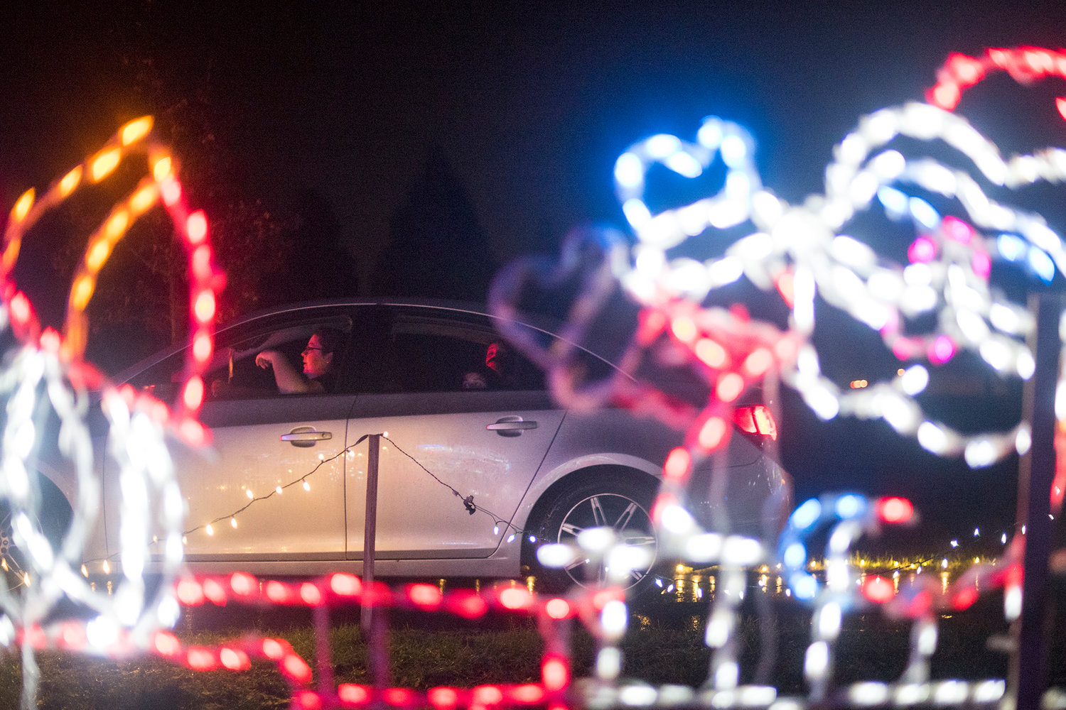 Kids look out the backseat window of a car at the Borst Park Christmas Lights on last year in Centralia.