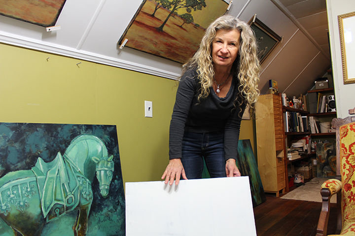 Centralia artist Sue Darius shows off a blank frame for a painting, built by her husband, Steve.