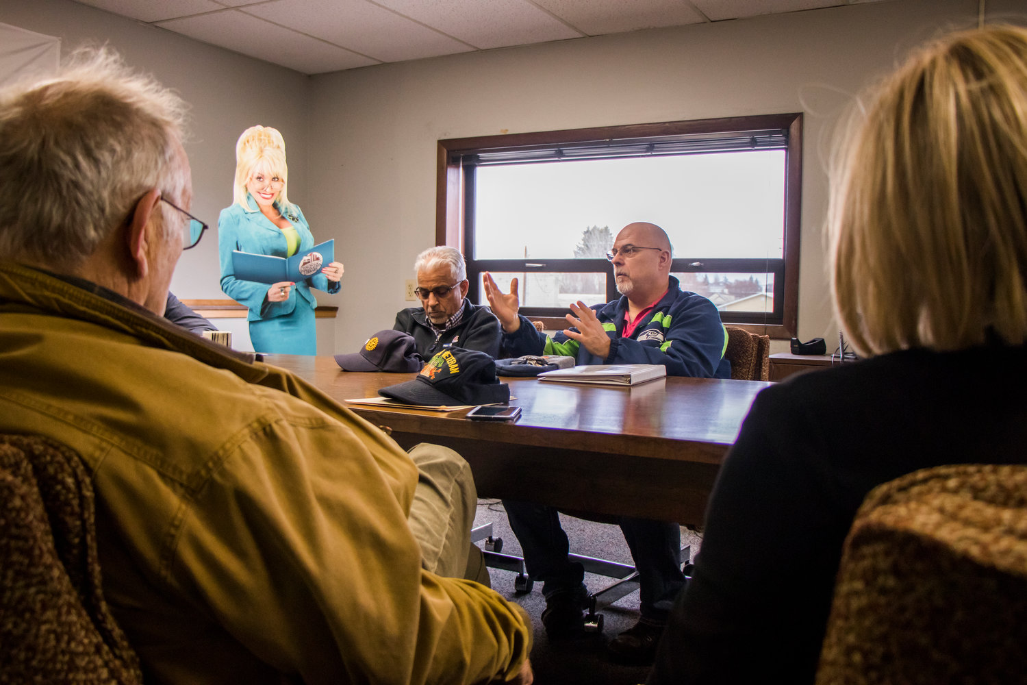 Anil Puri, left, listens as John Elmore talks about the benefits of the Dolly Parton Imagination Library at The Chronicle’s Centralia Office on Dec. 18. 