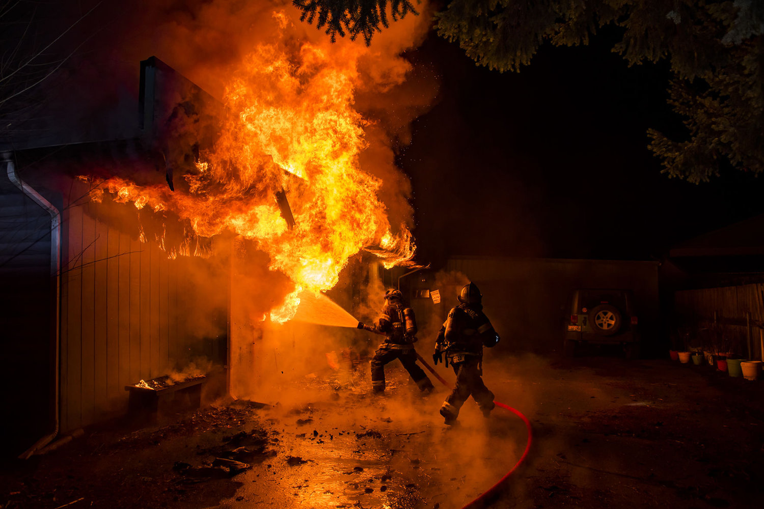 RFA firefighters rush to put out a house fire while spraying down a room fully engulfed in flames in the 1300 block of West Main Street Jan. 25, 2019 in Centralia.
