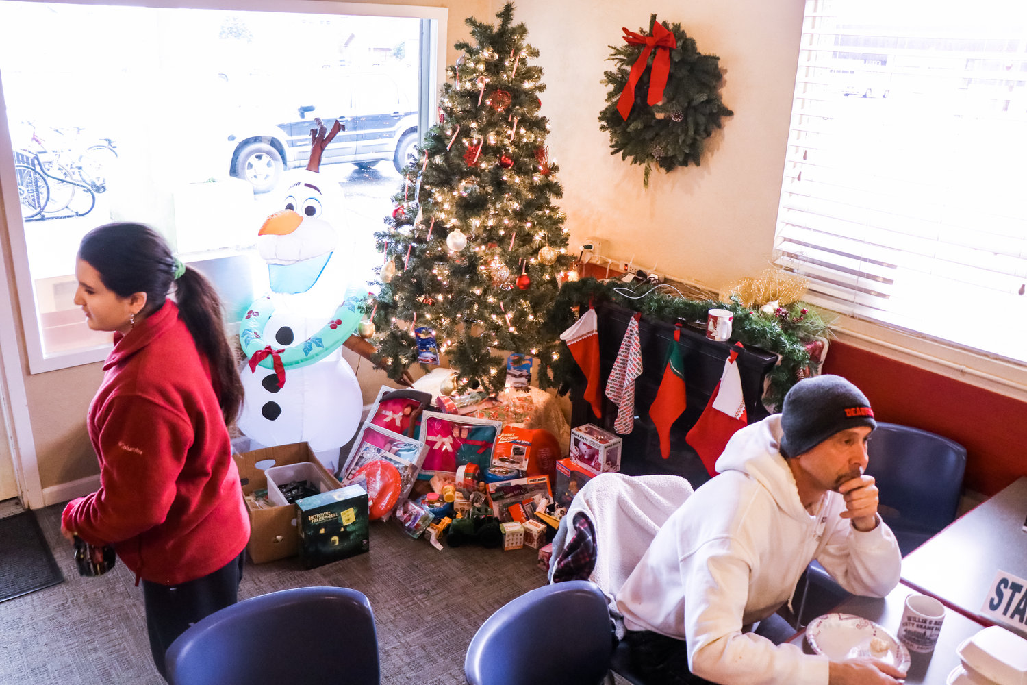 Presents sit under the tree as attendees enjoy a free brunch put on by Gather Church Wednesday afternoon in Centralia.