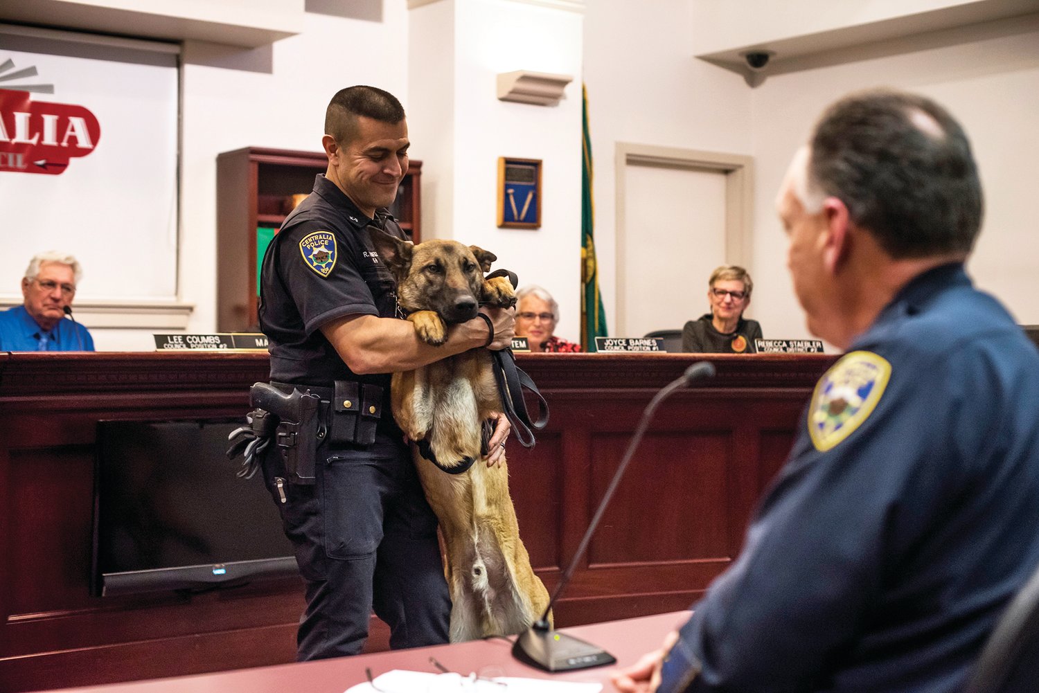Officer Reuben Ramirez shows off his new K9 partner, Pax, during the Centralia City Council meeting in this Chronicle file photo.