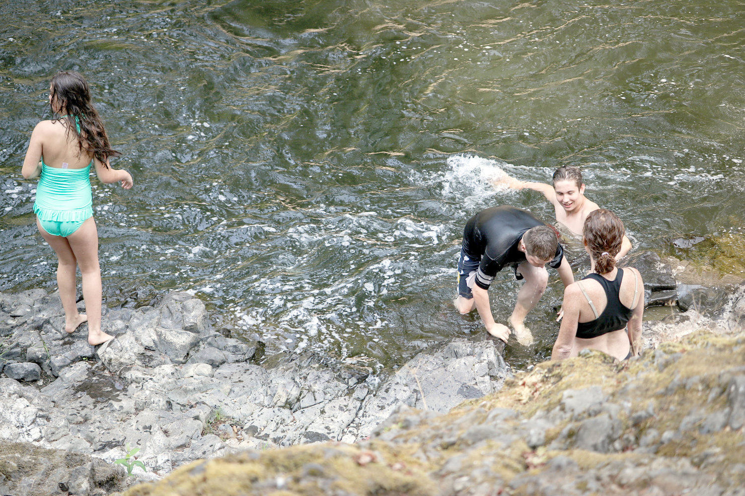 2017 FILE PHOTO — A family visiting from Texas hopped into the waters at Rainbow Falls.