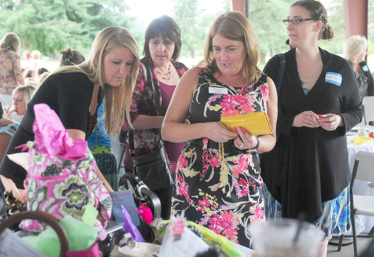 Women look at door prizes at Power of the Purse at Riverside Golf Course in Chehalis in this file photo.