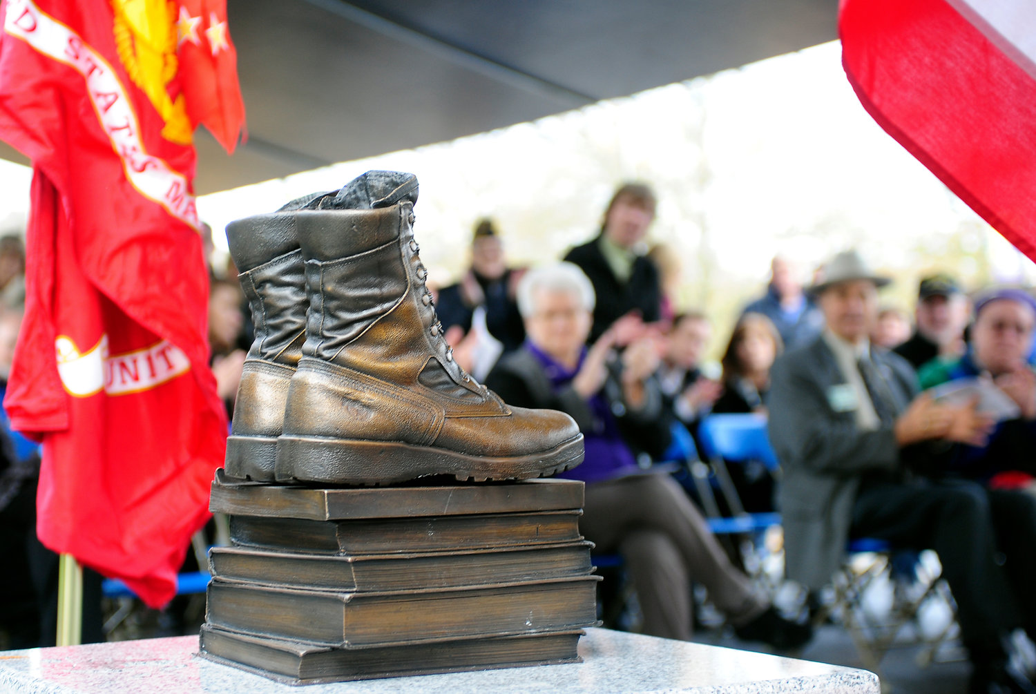 FILE PHOTO — The audience claps as a statue on Centralia College's campus called Boots-2-Books was revealed in honor of U.S. military veterans past, present and future in this file photo.