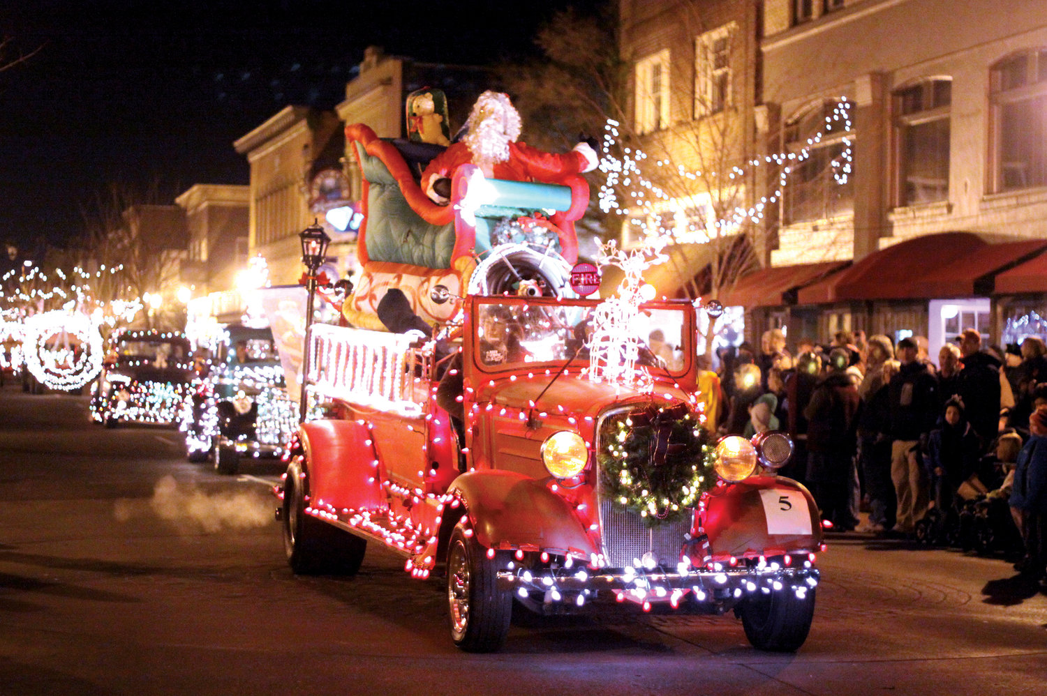 FILE PHOTO — Vehicles decorated with holiday finery stream down Tower Street in Centralia during the Centralia Downtown Association's second annual Lighted Tractor Parade in 2011.