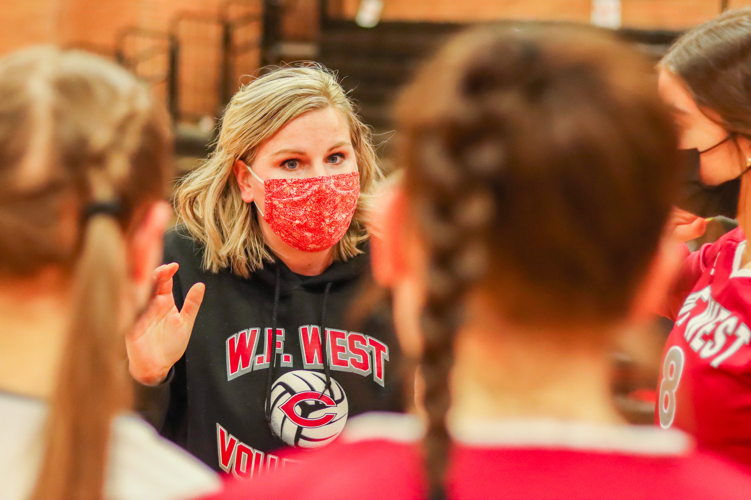 W.F. West's Head Coach Emily Mora talks to players during a Swamp Cup game against the Tigers Tuesday night in Centralia.