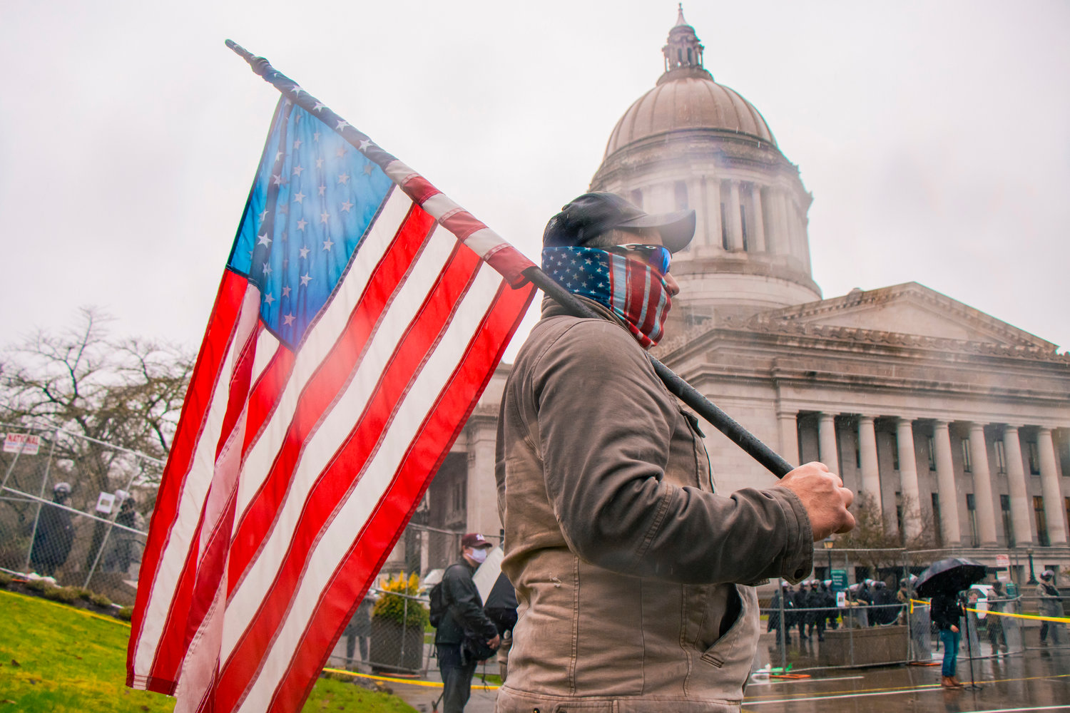 A protester walks outside of the Washington State Capitol building last January in Olympia.