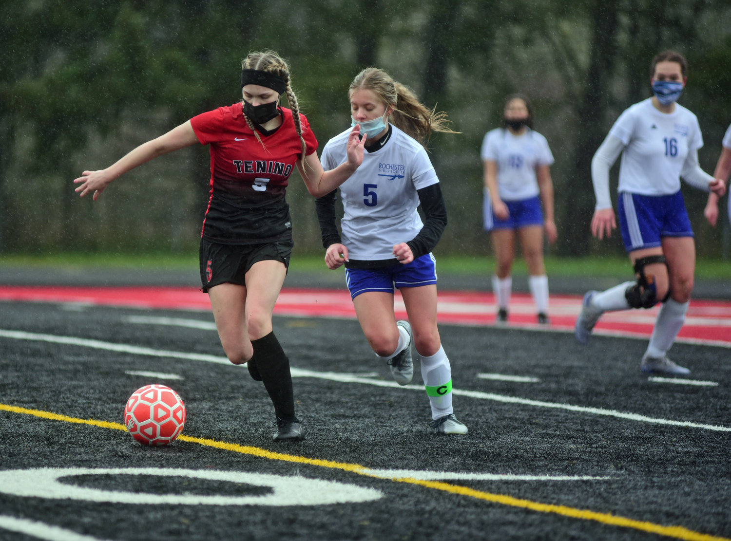 Tenino's Morgan Miner (5) and Rochester's Megan Haury (5) battle for a ball on Saturday.