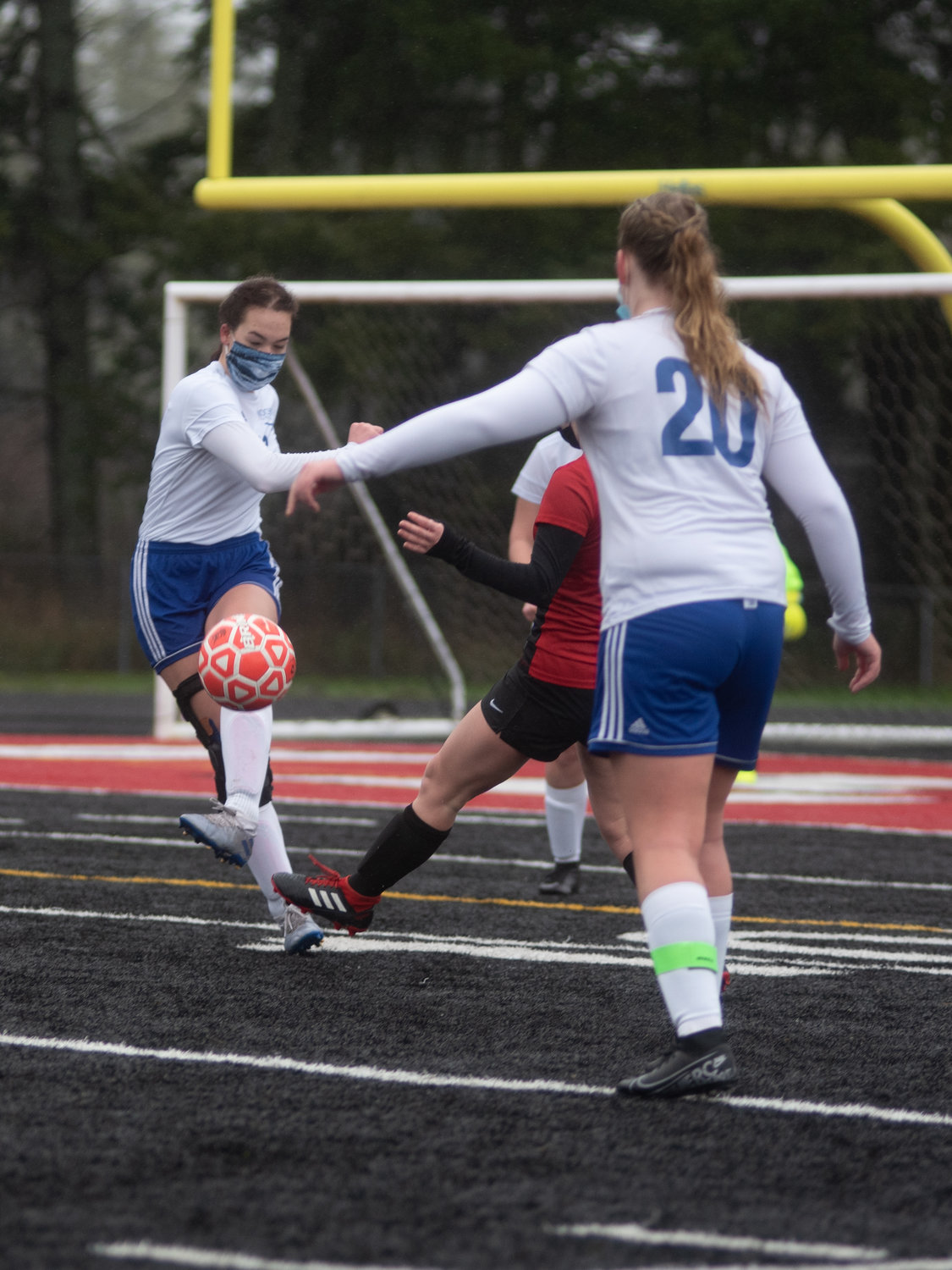 Rochester junior midfield Sophie Sand, left, boots the ball against Tenino on Saturday.