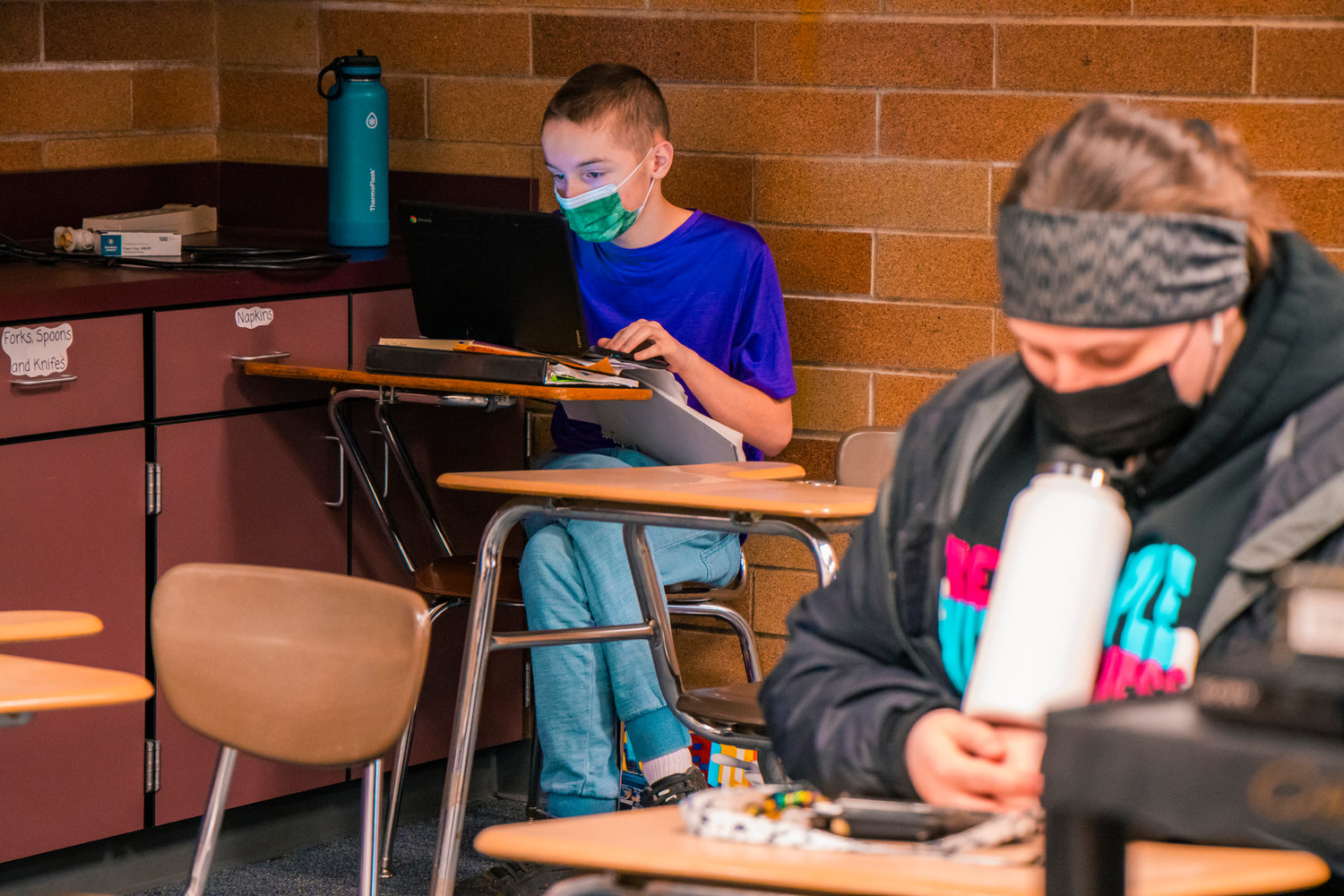 Onalaska students sport masks as they work on assignments in class on Tuesday.