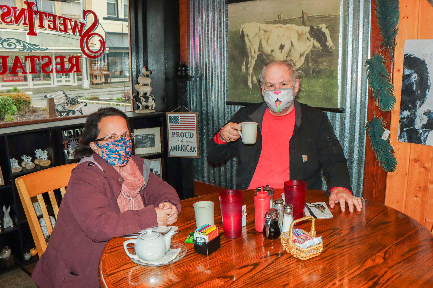 Lynn and Robert Suchanek pose for a photo raising a glass as they sit down to eat at Sweet Inspirations in Chehalis Monday morning.