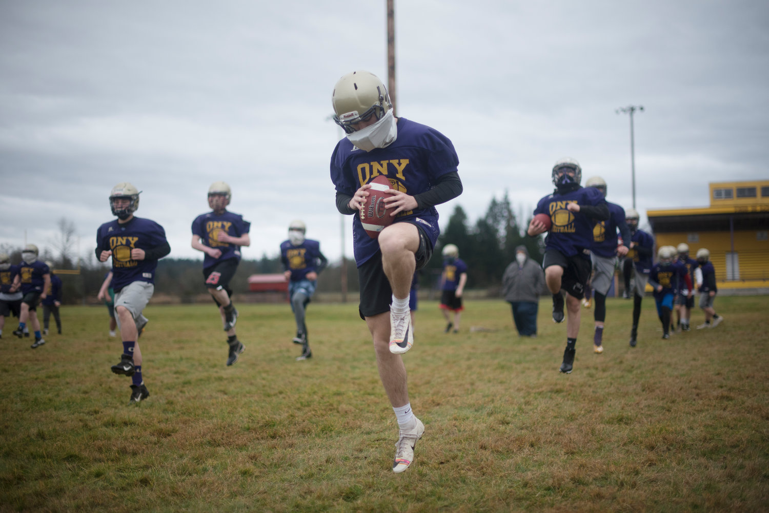 Onalaska football players run through warmup drills during the first day of official team practices on Monday, Feb. 1, 2020.
