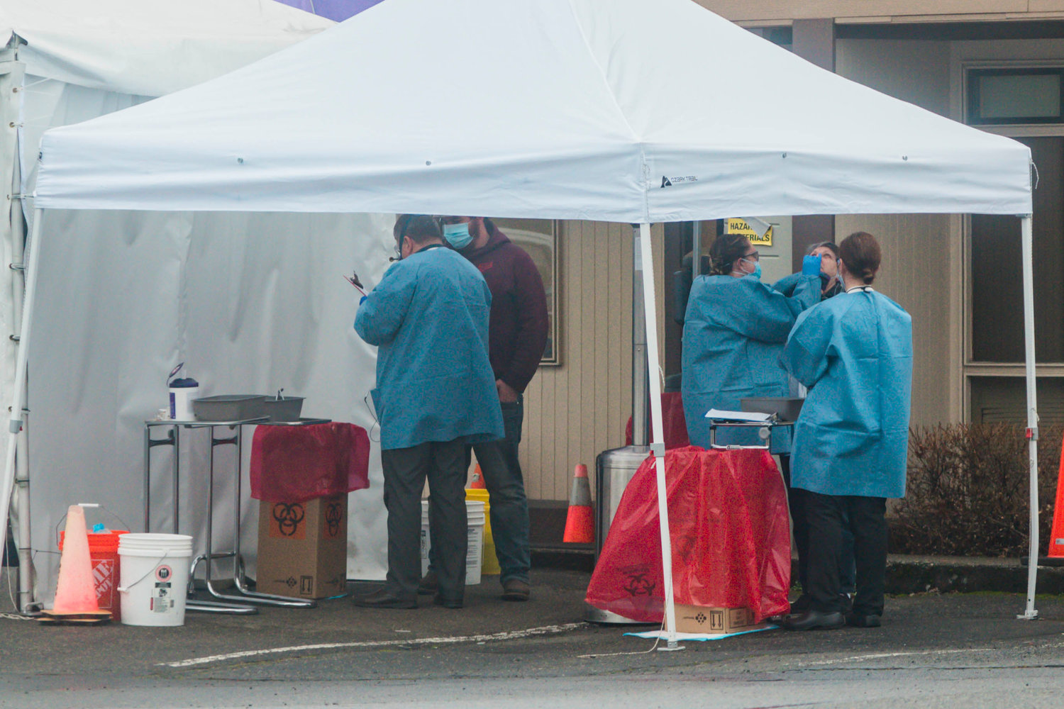 Medical professionals conduct COVID-19 swab tests at Valley View Health Center in Centralia last December. 