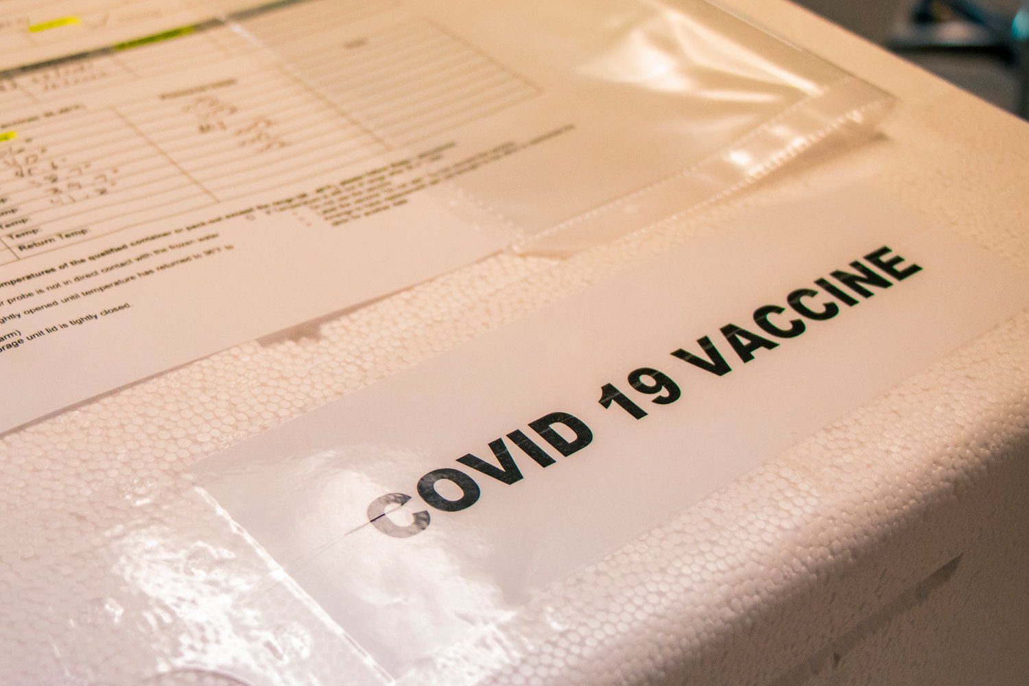 FILE PHOTO — A cooler containing the Pfizer COVID-19 vaccine sits on a table at Prestige Post-Acute and Rehab Center in Centralia.