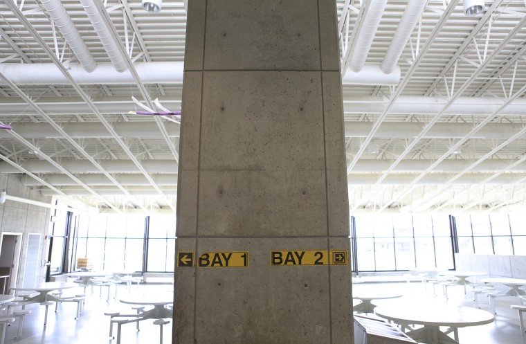 Inside Green Hill, pillars with labels in a large room designate inmate areas.