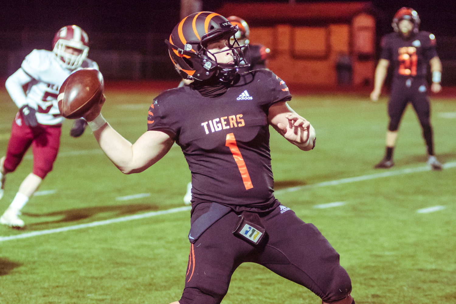Centralia's Quarterback Cameron Erickson (1) looks to throw during the Swamp Cup football game against the Bearcats Saturday night at Tiger Stadium.