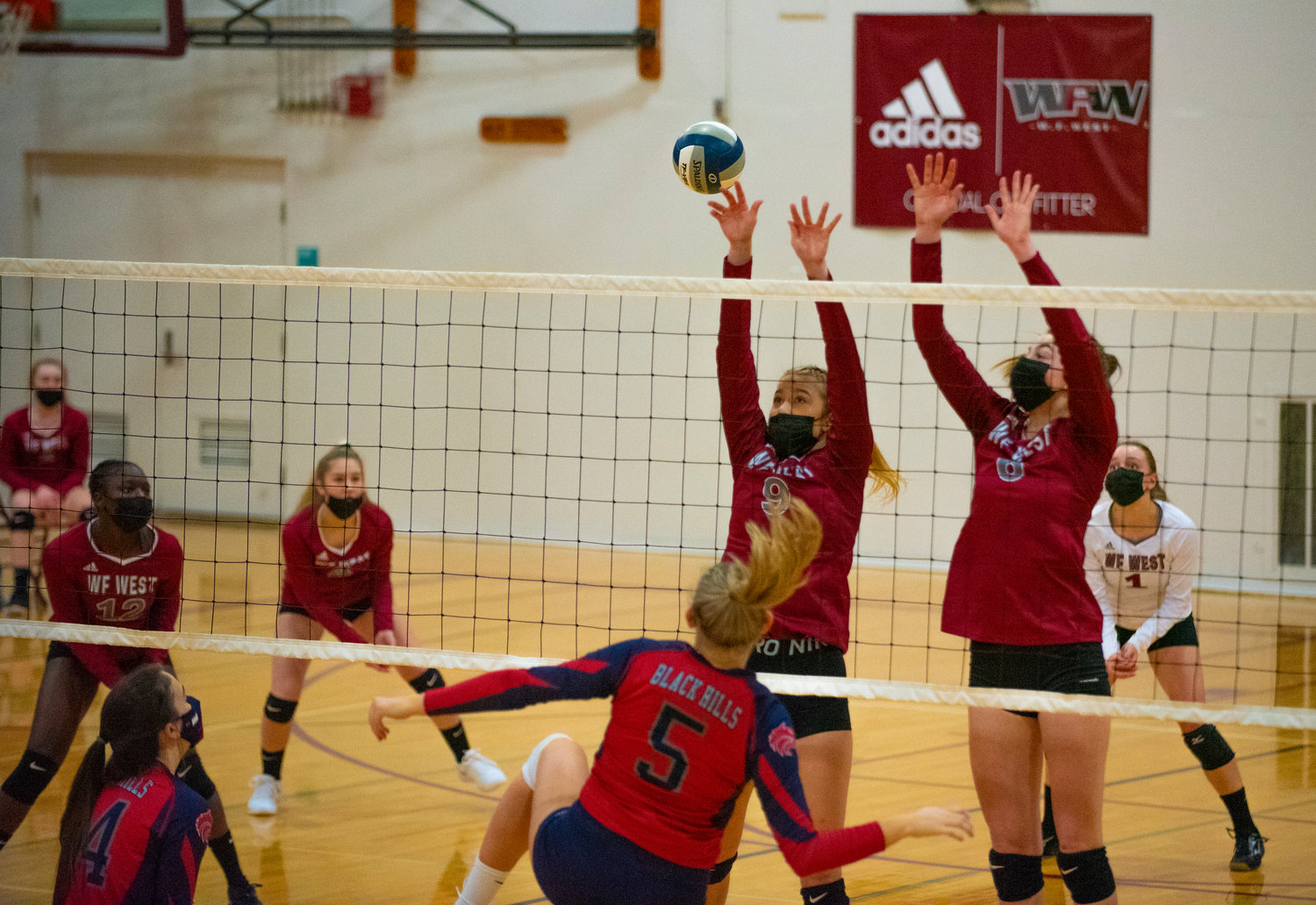 W.F. West's Ava Olsen (9) and Morgan Rogerson (6) go for a block against Black Hills.