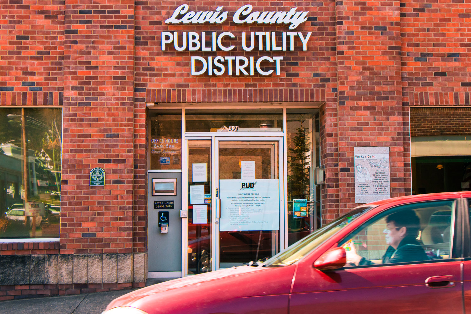 A car drives by the Lewis County Public Utility District office on Friday in Chehalis.