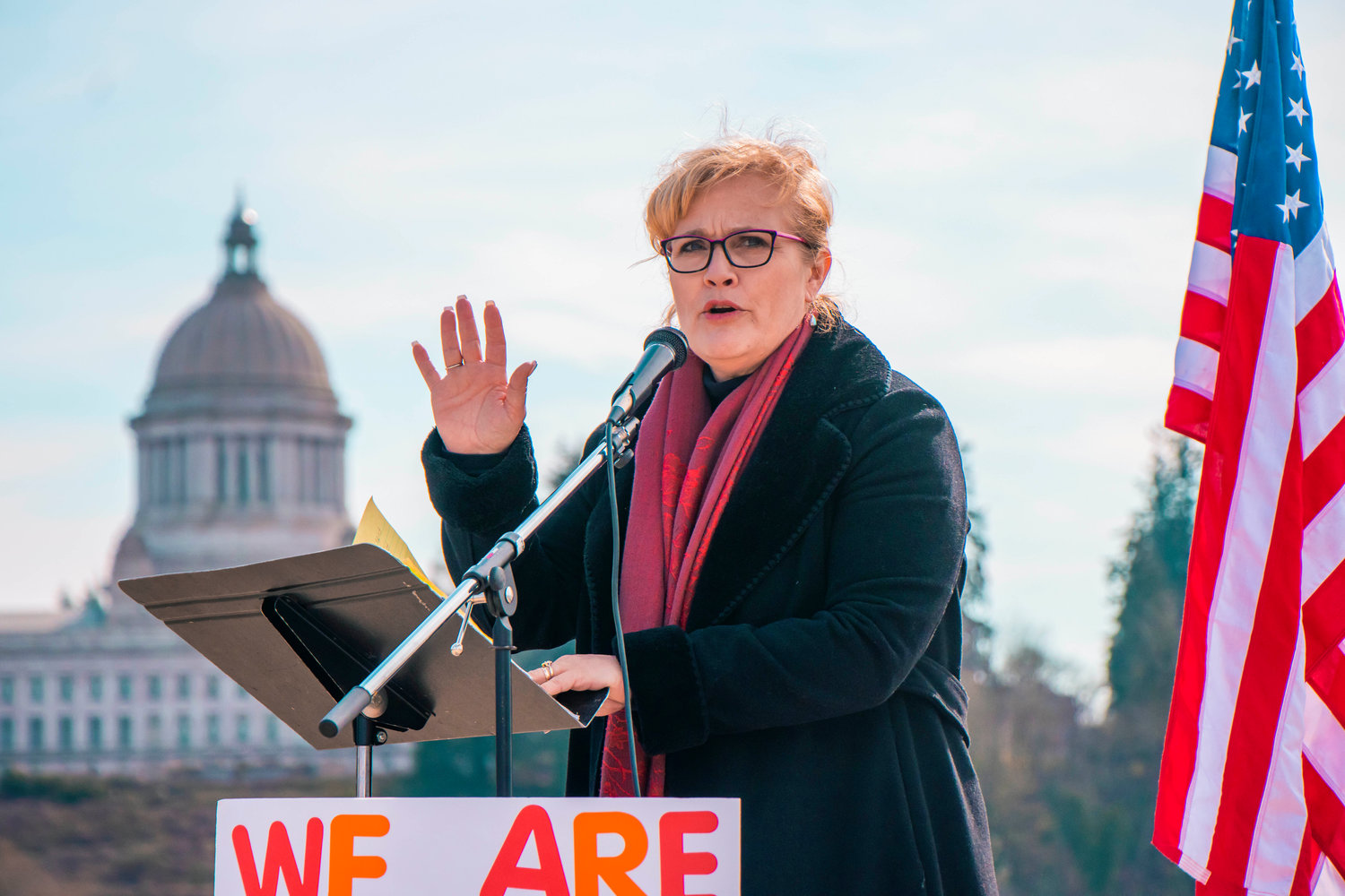 Michelle Darnell, President of the Ignite Foundation LLC, speaks during a rally in support of bringing back in-person schooling near Capitol Lake on Saturday in Olympia.