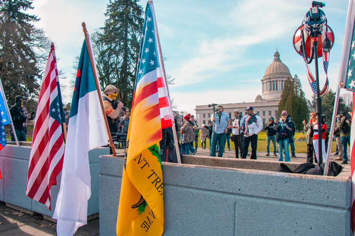Flags wave as protesters gather for a rally in support of open carry rights near the Washington State Capitol building in Olympia on Saturday.