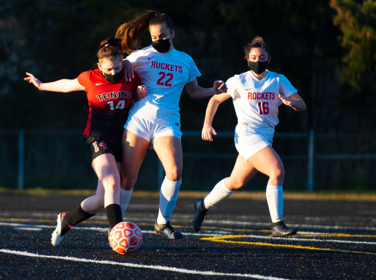 Tenino's Kamryn Oliveira (12) battles with Castle Rock's Camilla Scandeletti (22) and Zoey Snow (16) on Monday.