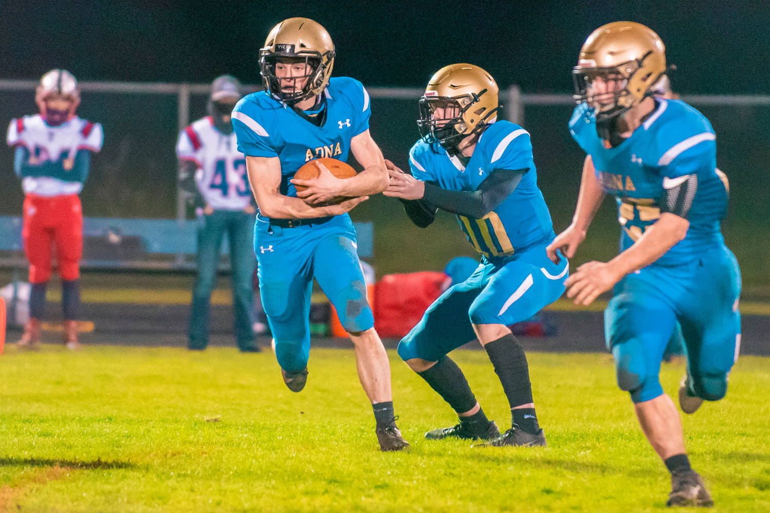 Adna’s Lane Johnson (10) hands the ball off to Tristan Ridley (9) during a game against PWV in Adna on Wednesday.