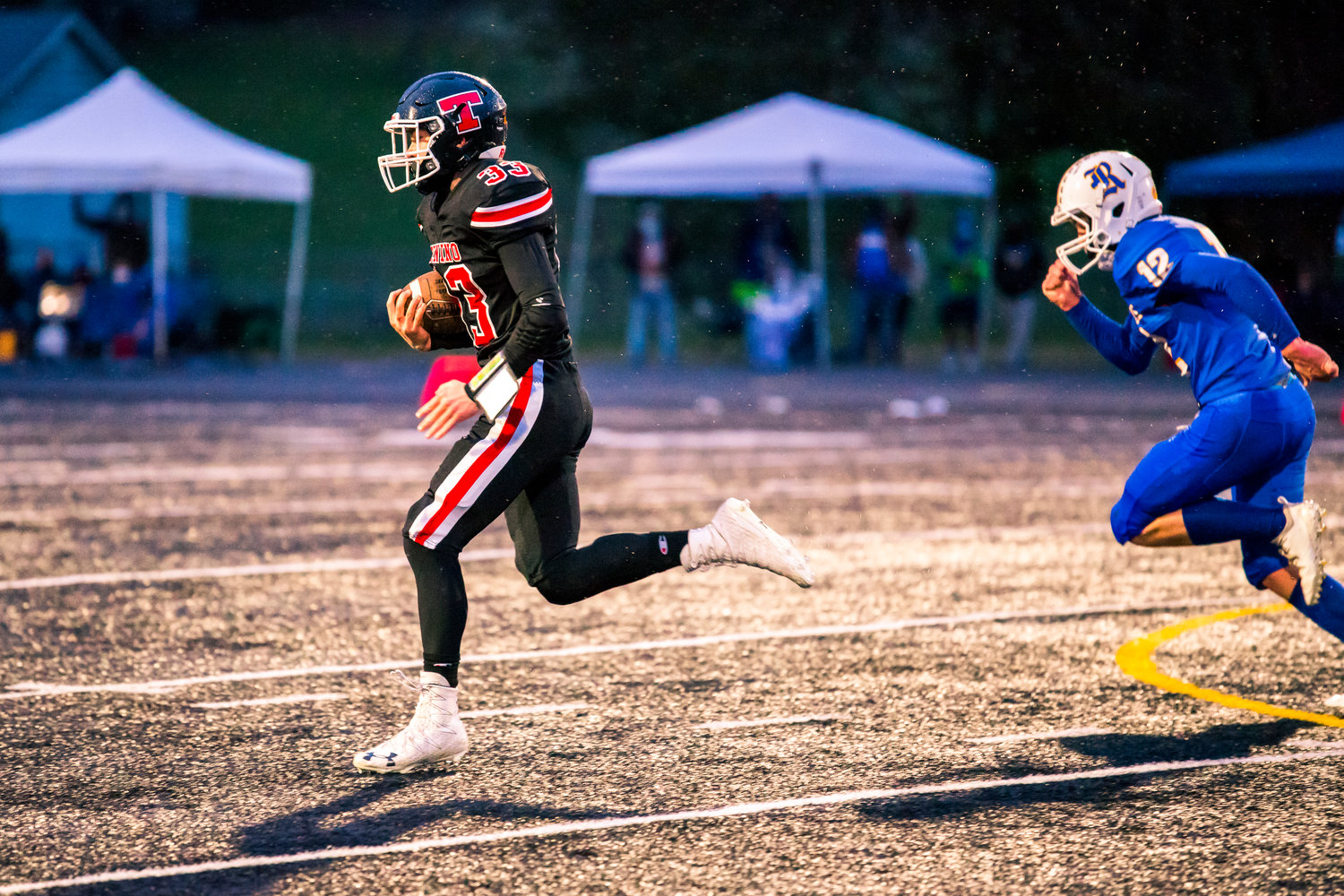 Tenino's Gavin Watson (33) runs with the football during a game against Rochester Friday night.
