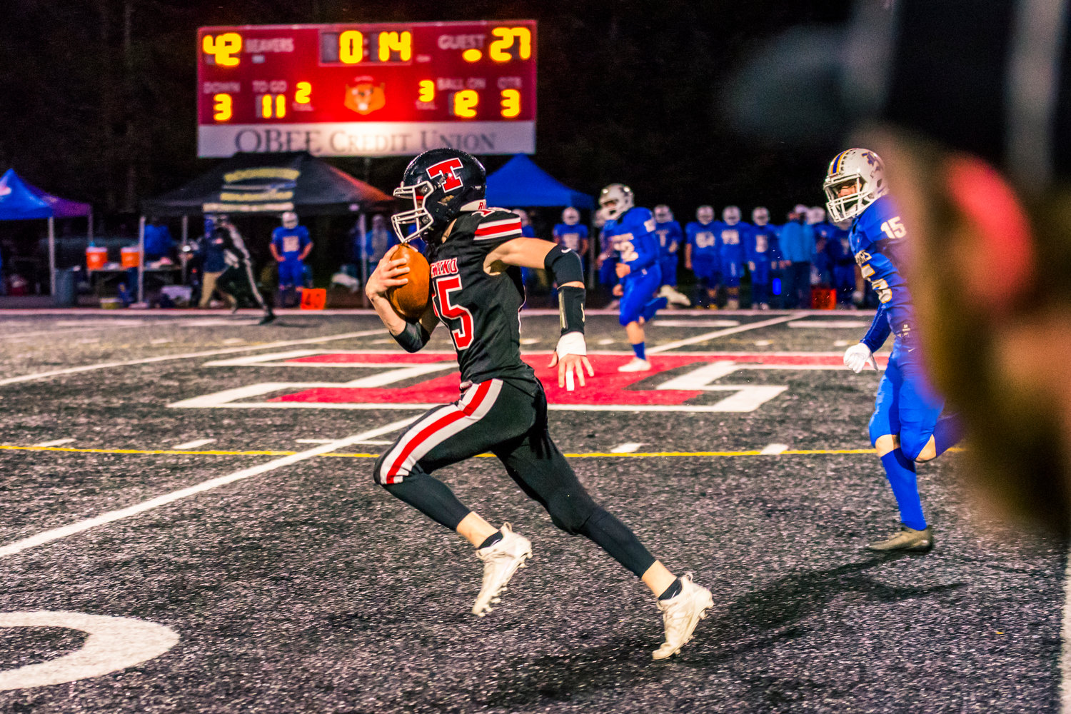 Tenino's William Tennihill (15) runs for a touchdown during a game against Rochester Friday night.