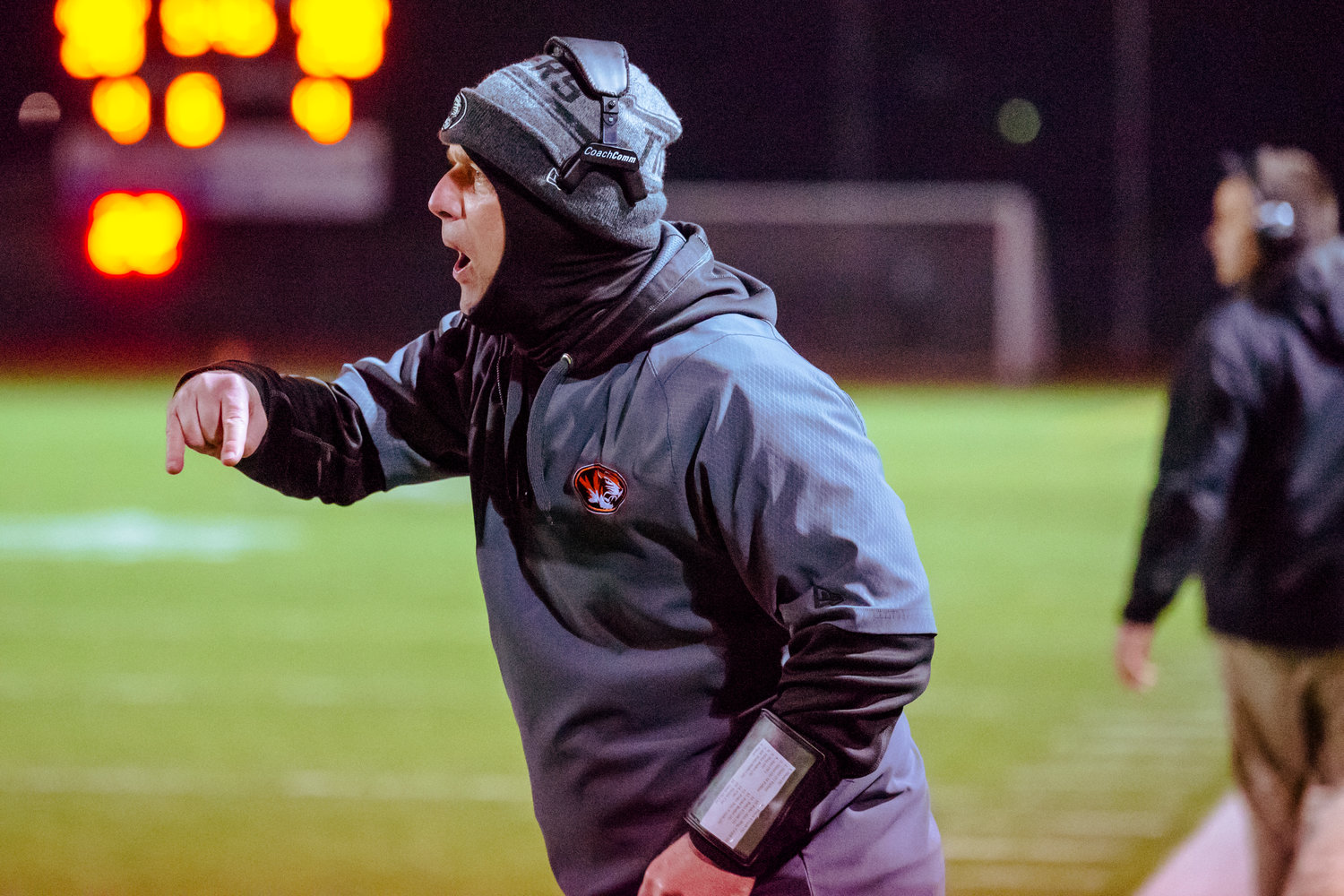Napavine's coach yells to players on the field during a game against Onalaska Saturday night at Tiger Stadium.