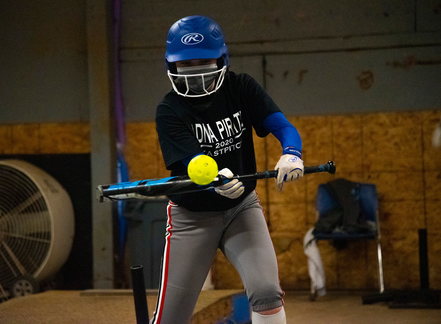 Adna's Ali Davis works on bunting during a rainy-day practice in the batting cages March 19.