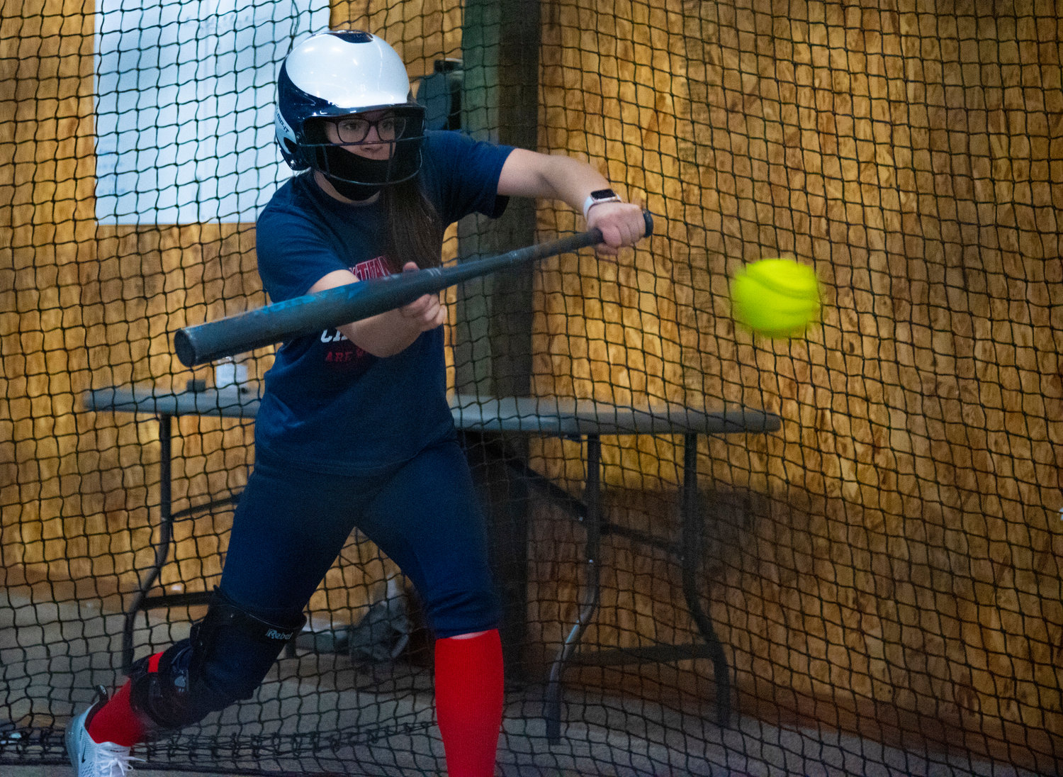 Pe Ell-Willapa Valley's Raegan Portmann works on bunting in the batting cage on March 19.