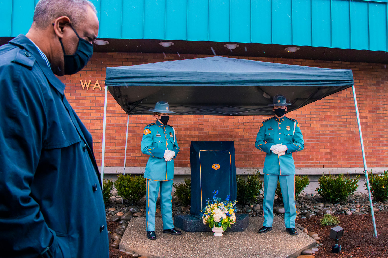 Washington State Patrol Chief John R. Batiste walks by the monument before an unveiling during a dedication ceremony Wednesday morning in Chehalis for Justin R. Schaffer.
