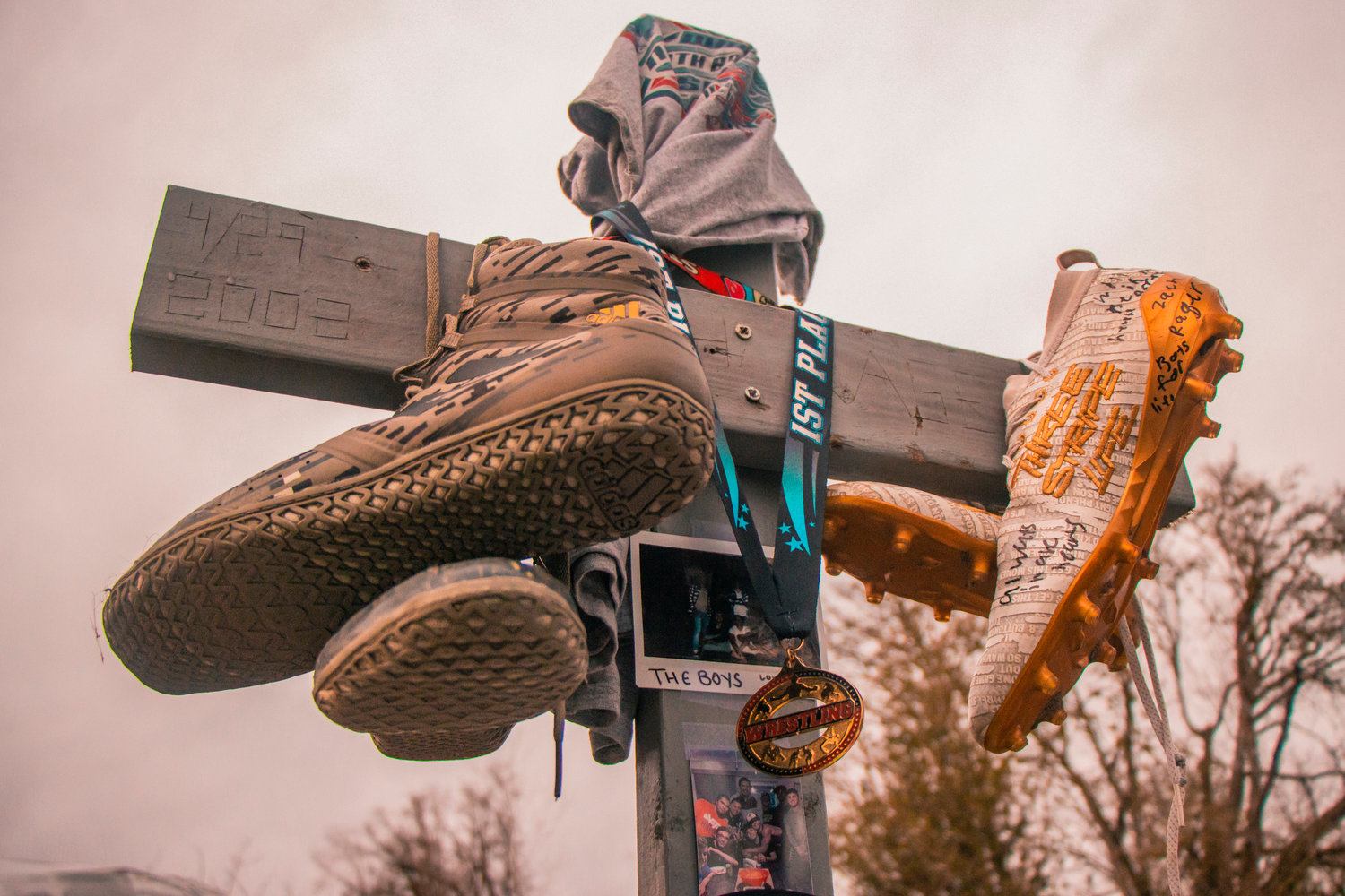 Athletic footwear and medals hang from a cross near the Adna trestle Wednesday along the Willapa Hills Trail.