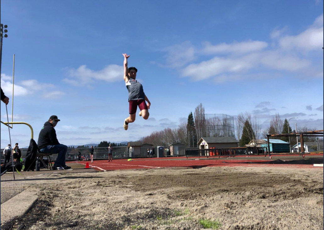 FILE PHOTO - W.F. West’s Seth Hoff launches into the long jump pit in Tumwater.