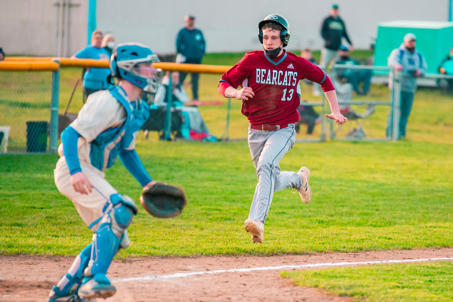 Bearcats’ Gavin Fugate (13) runs towards home plate while trying to score during a game against the Warriors in Rochester on Wednesday.