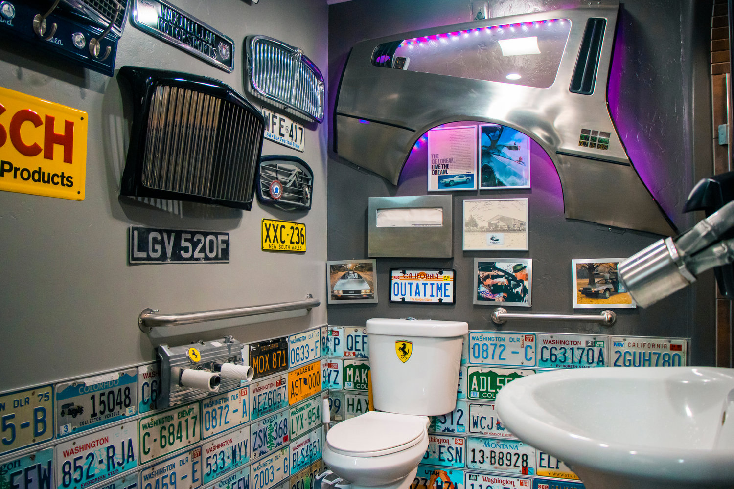 The bathroom at Maximilian Motorsports is seen decked out in styled vehichle parts and various license plates in Chehalis on Thursday.