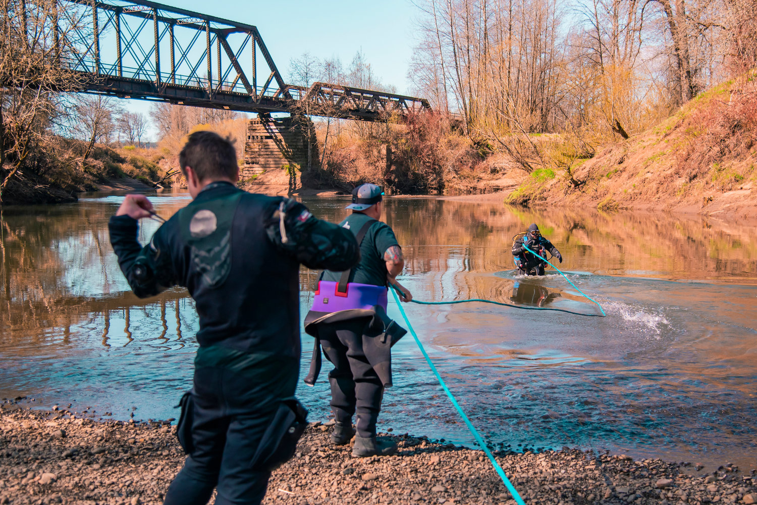 Independent volunteer divers Corey Cooper, Jefferson Greenwell, and Jim Baker use a rope during a search for missing teen Zach Hines-Rager in the Chehalis River near Adna.