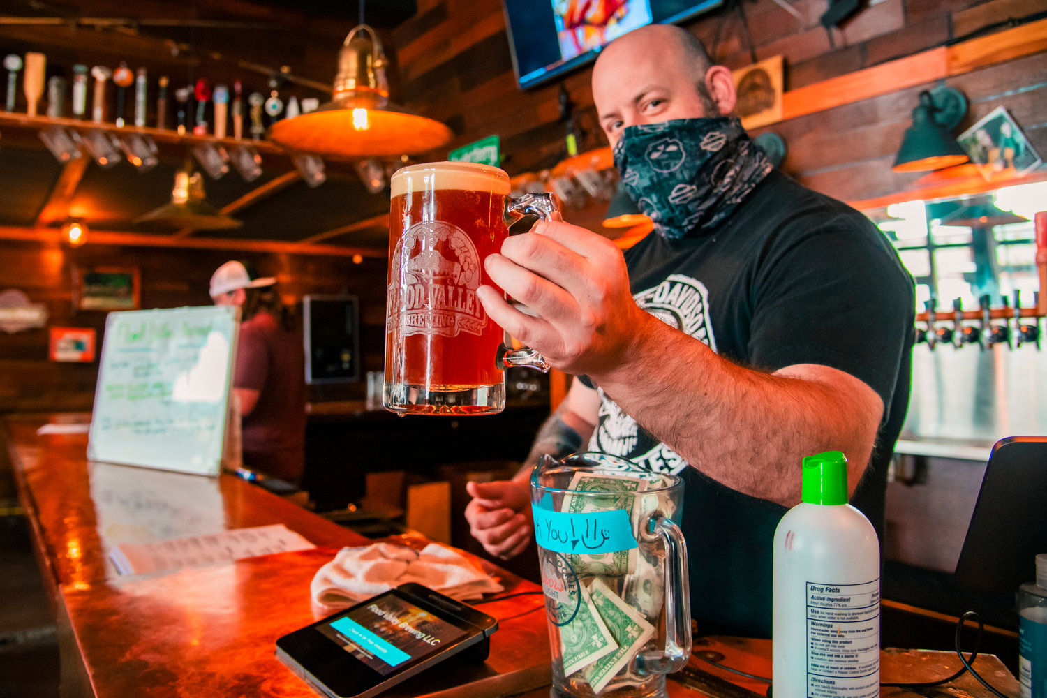 Chris Rohr, owner of Flood Valley Brewing Craft Taphouse, holds up a mug of the new “Chehalis Ave IPA” ordered on Friday in Chehalis.