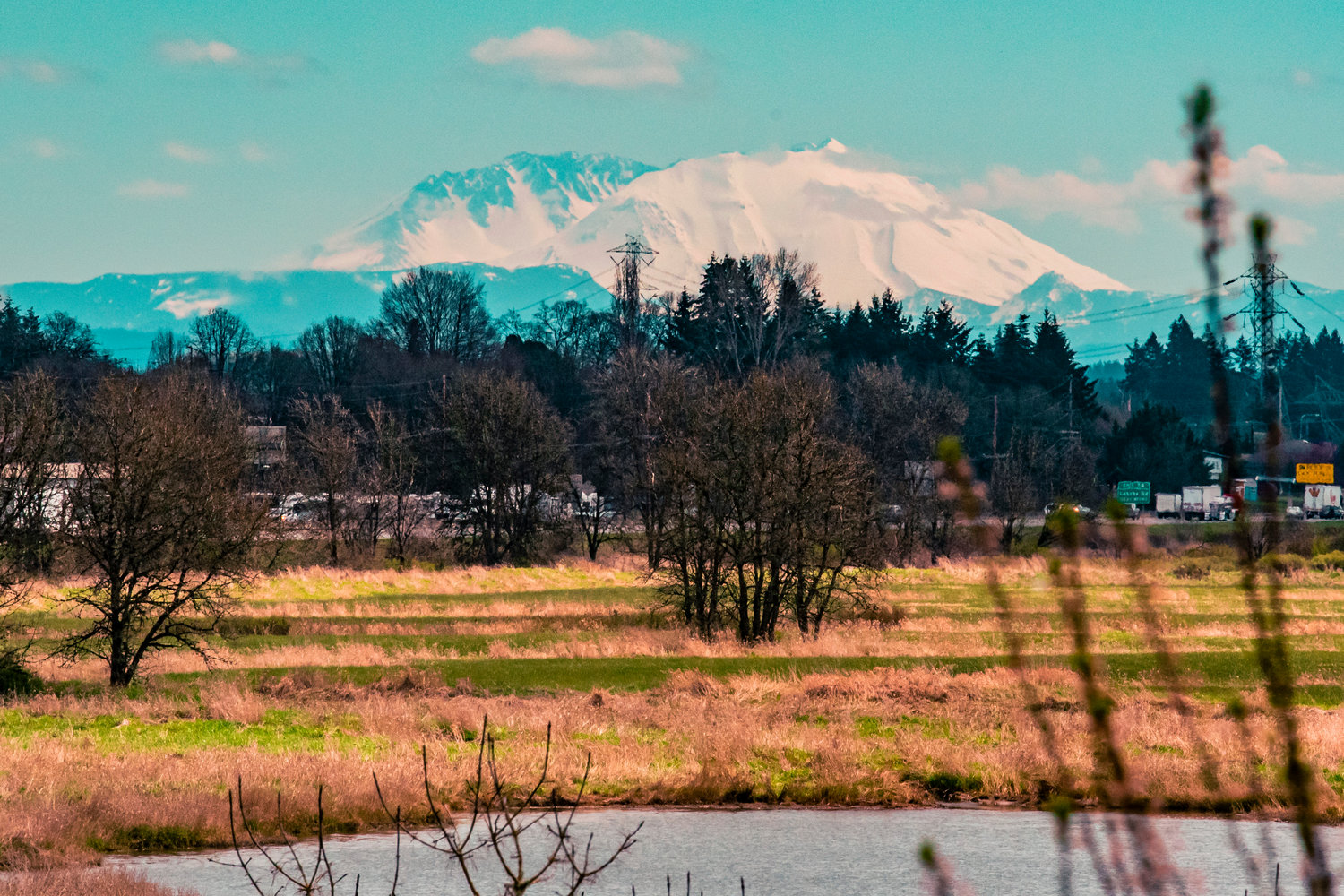 Mount St. Helens is seen over trees and Interstate 5 from Chehalis on Friday.