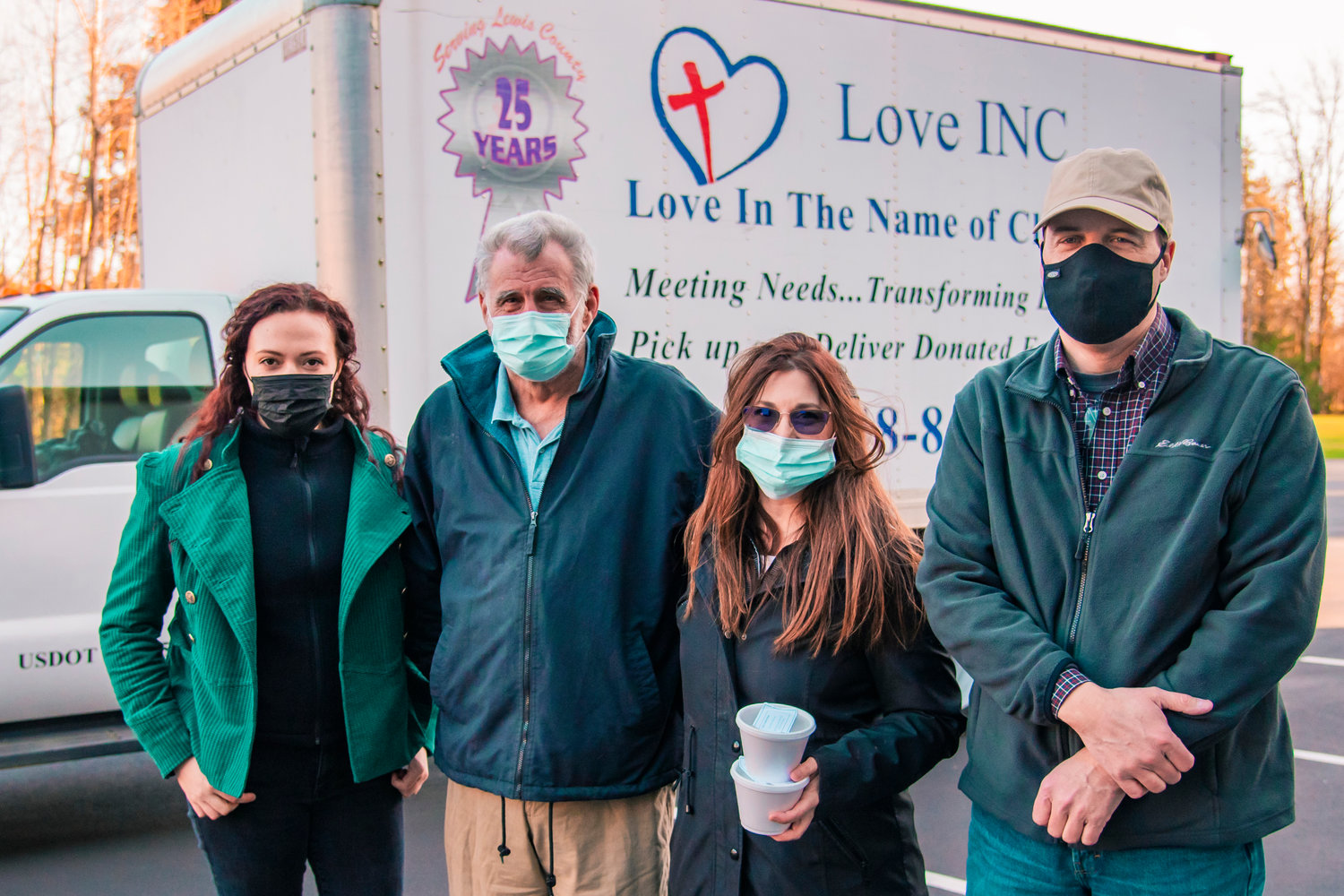 From left, volunteer coordinator Payton Zandofsky, warehouse volunteer Dan Gleichman, organizer Melodee Bailey and Executive Director Brian Carlton pose for a photo in front of the Love INC truck parked at Cooks Hill Community Church on Saturday in Centralia during a “Souper Supper” event.