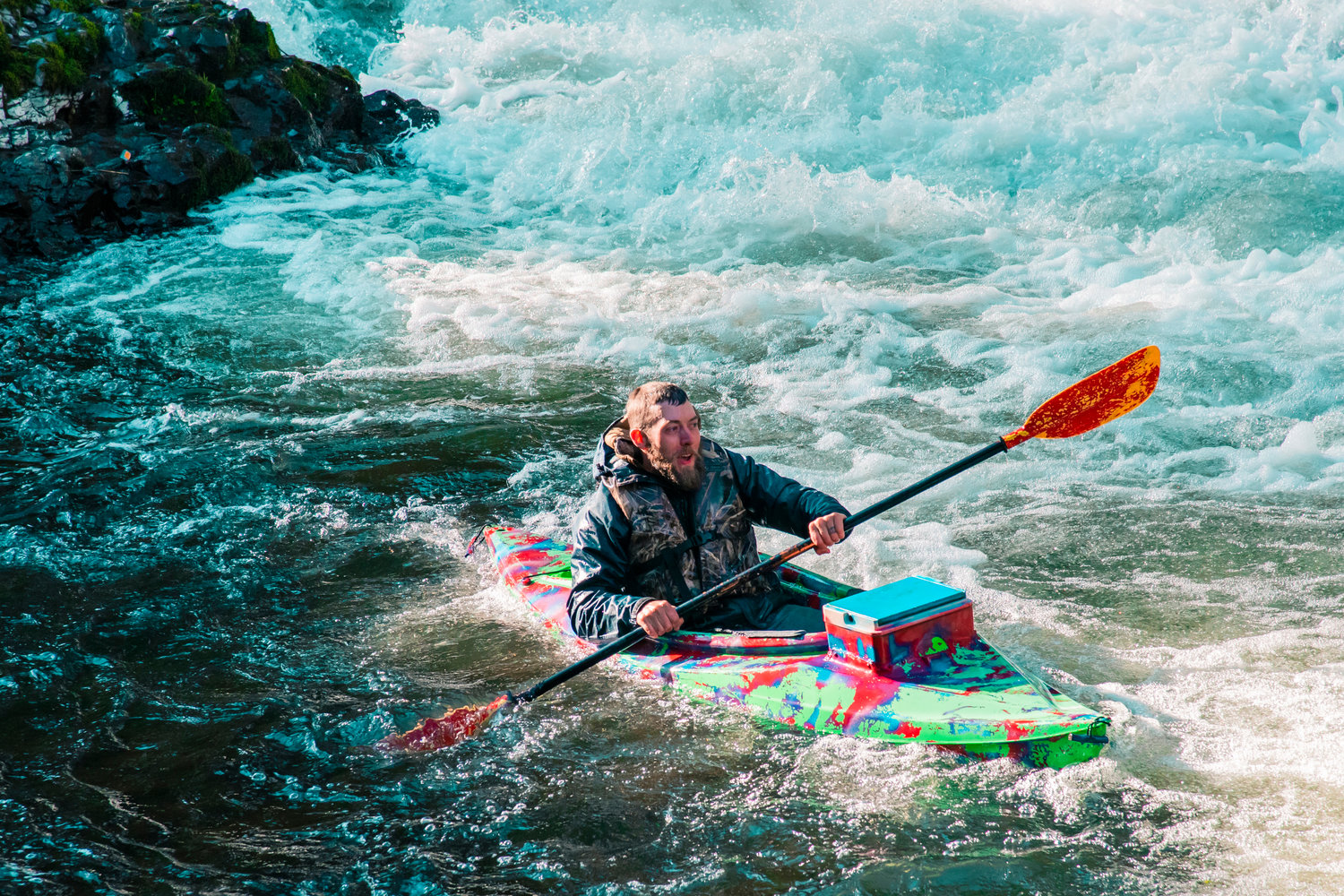 A kayaker paddles out of the Chehalis River after going over Rainbow Falls during the Pe Ell River Run on Saturday.