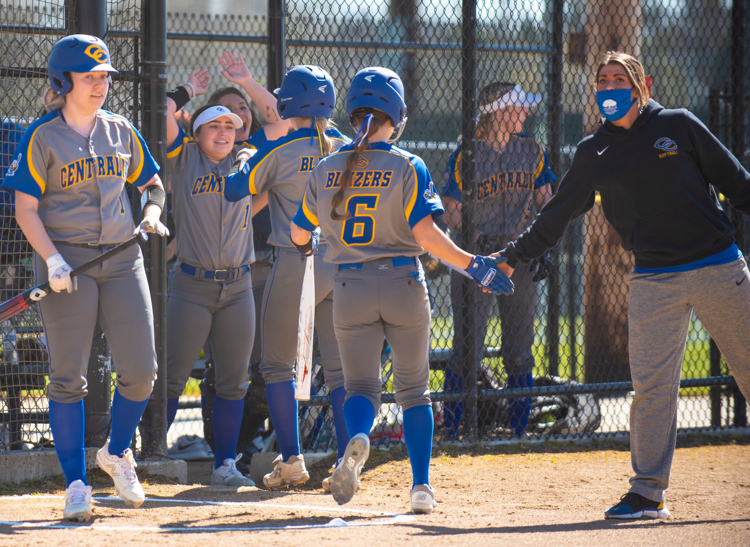 Centralia College players congratulate Katie Adkins and Nicole Schock scoring first-inning runs on Monday.