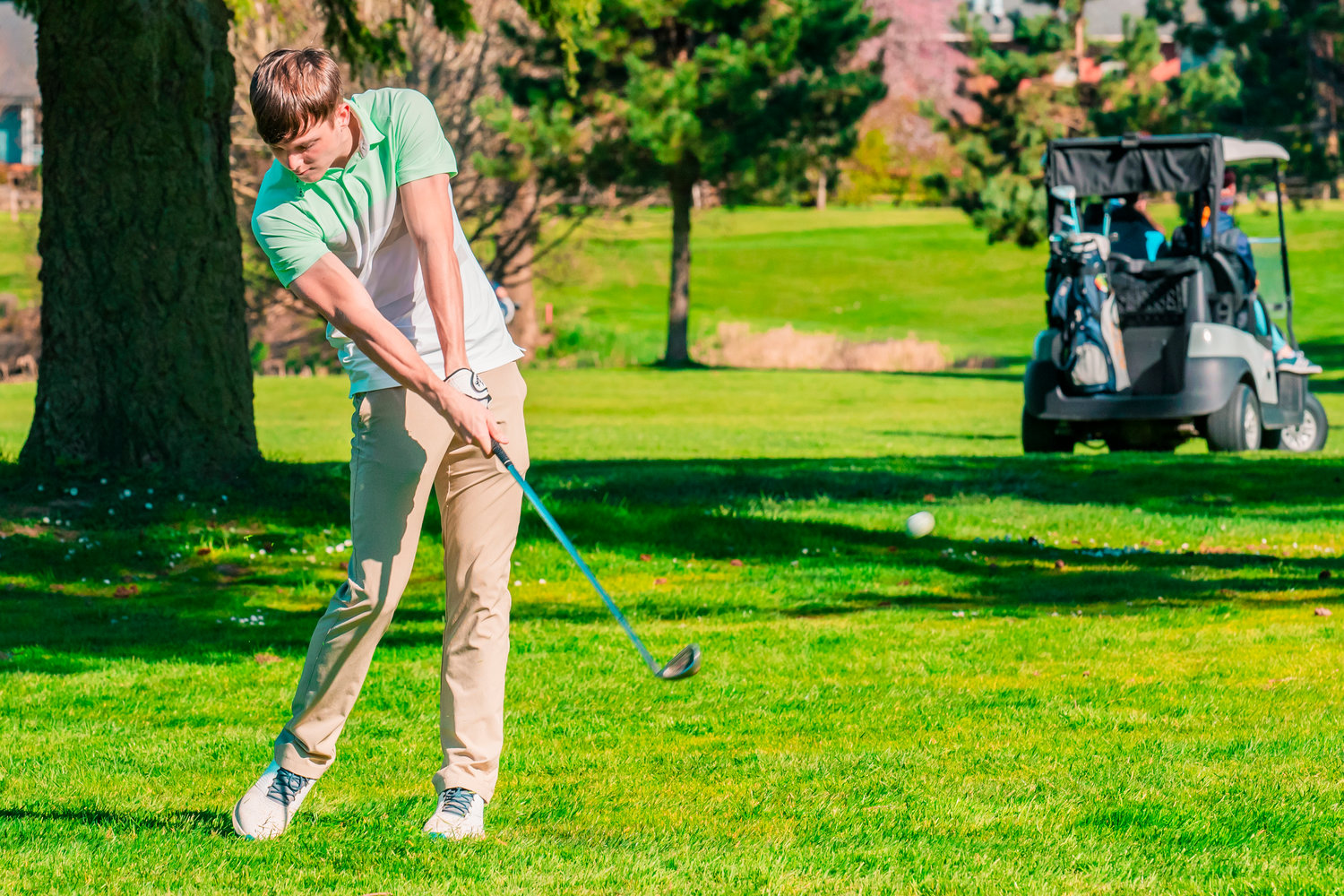 Adna’s Chase Collins makes contact at Riverside Golf Course in Chehalis on Monday.